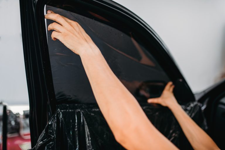 Specialist work with car, tinting film installing